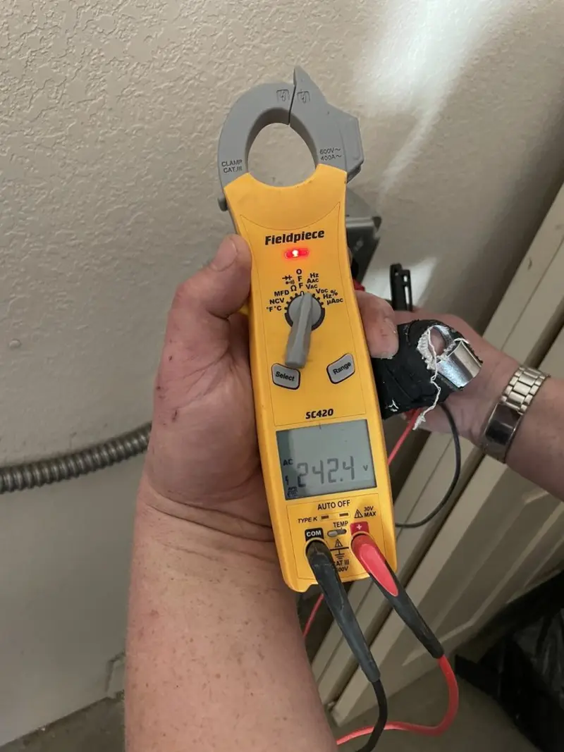 Voltage testing with clamp meter during Whole House Surge Protector in Van